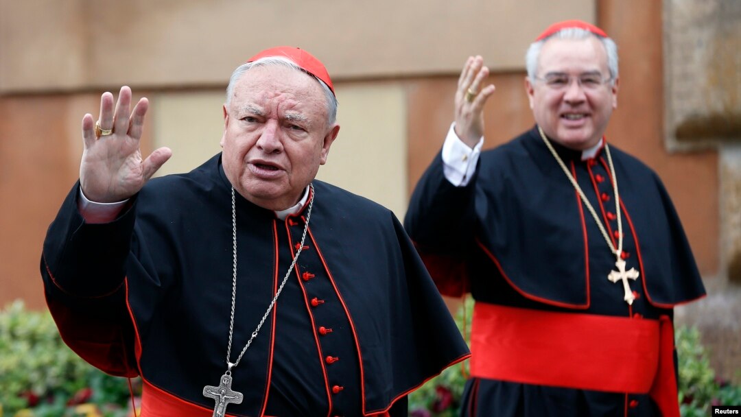 Mexican Cardinals Juan Sandoval Iniguez (L) and Josz Francisco Robles Ortega (R) wave as they arrive at a meeting at the Synod Hall in the Vatican March 7, 2013.