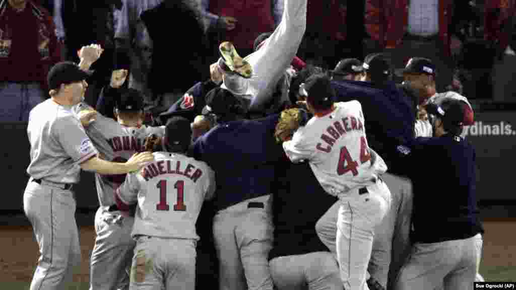 Boston Red Sox players celebrate after beating the St. Louis Cardinals 3-0 in Game 4 to sweep the World Series Wednesday, Oct. 27, 2004, in St. Louis. It was the first World Series championship for Boston since 1918.