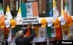 A man sells Pope Francis souvenirs at a stall in Dublin, Ireland, Aug. 24, 2018.