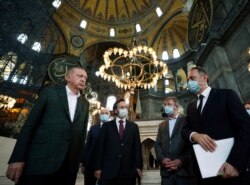 El presidente de Turquía, Recep Tayyip Erdogan (izquierda), escucha a un funcionario durante una visita a la Hagia Sophia, la catedral de la era bizantina, que es una de las principales atracciones turísticas de Estambul. Julio 19 de 2020.