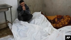 A Palestinian man mourns relatives killed in overnight Israeli airstrikes on the Maghazi refugee camp at Al-Aqsa Hospital in Deir al-Balah, central Gaza Strip, Dec. 28, 2024. 