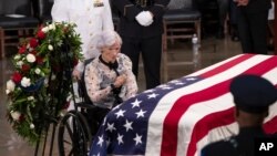 Roberta McCain, the mother of Sen. John McCain of Arizona, stops at his flag-draped casket in the U.S. Capitol rotunda during a farewell ceremony, Aug. 31, 2018, in Washington.
