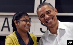 President Barack Obama shares a laugh with a 16-year-old refugee from Myanmar after speaking about the refugee situation during a visit to the Dignity for Children Foundation in Kuala Lumpur, Malaysia, Nov. 21, 2015.