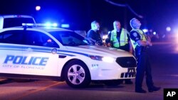Authorities direct traffic on Hoffmeyer Road near the Vintage Place neighborhood where several law enforcement officers were shot, one fatally, Oct. 3, 2018, in Florence, S.C.