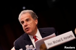 FILE - Justice Department Inspector General Michael Horowitz testifies during a Judiciary Committee hearing into alleged Russian meddling in the 2016 election on Capitol Hill in Washington, July 26, 2017.