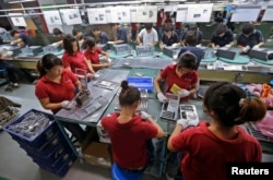 Employees work at a Foxconn factory in Wuhan, Hubei province, China, Aug. 31, 2012.