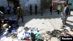 Clothes and shoes are seen at the site of a suicide bomb attack in Kabul, Afghanistan, April 22, 2018.