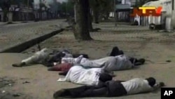 According to The Associated Press, Nigerian officials dumped dozens of corpses in front of a hospital after soldiers opened fire on civilians. Frame grab from TV footage shot by Nigeria's television authority shows people lying down (condition unknown) on a street in Maiduguri, Oct. 8, 2012.