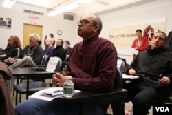 Philip Malebranche, center, spends much of his time volunteering for Care for the Homeless. He spent much of the past 17 years in New York City shelters, but secured a room in 2016. (R. Taylor/VOA)