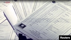Documents identifying supporters of Islamic State are seen in this still image from video, released by Sky News to Reuters in London, March 10, 2016.
