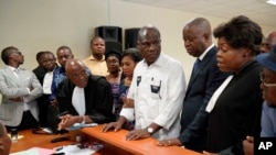 FILE - Accompanied by his wife and his lawyers, Congo opposition candidate Martin Fayulu, center, petitions the constitutional court following his loss in the presidential elections in Kinshasa, Congo, Jan. 12, 2019.