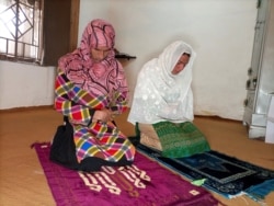 Rani Khan, perempuan transgender, berdoa bersama salah satu siswanya di Islamabad, Pakistan 10 Maret 2021.(REUTERS / Salahuddin)