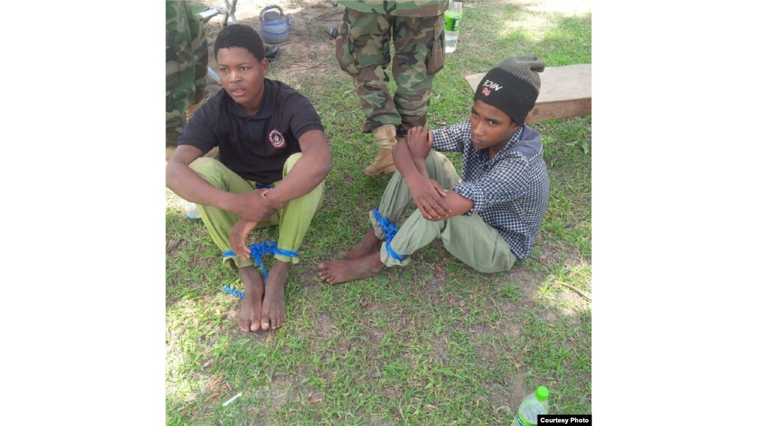 Young men described as foreign fighters are seen after being captured by the Nigerian military during an operation in Balmo forest. (Nigerian Ministry of Defense)