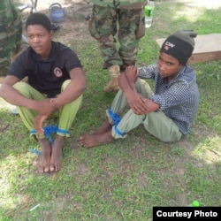 Young men described as foreign fighters are seen after being captured by the Nigerian military during an operation in Balmo forest. (Nigerian Ministry of Defense)