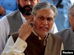 FILE - Pakistan's Finance Minister Ishaq Dar is seen after a party meeting in Islamabad, Pakistan, Sept. 26, 2017.