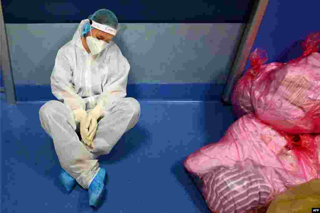 A medical worker in personal protective equipment (PPE) rests at the COVID 3 level Intensive Care Unit (ICU) at the Casal Palocco hospital, near Rome, Italy.