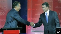 Republican presidential candidates former Massachusetts Governor Mitt Romney (L), and Texas Governor Rick Perry shake hands at the finish of a Republican presidential candidate debate at the Ronald Reagan Presidential Library in Simi Valley, California, S