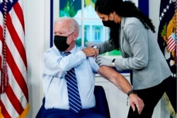 FILE - President Joe Biden receives a COVID-19 booster shot during an event in the South Court Auditorium on the White House campus, Sept. 27, 2021, in Washington.