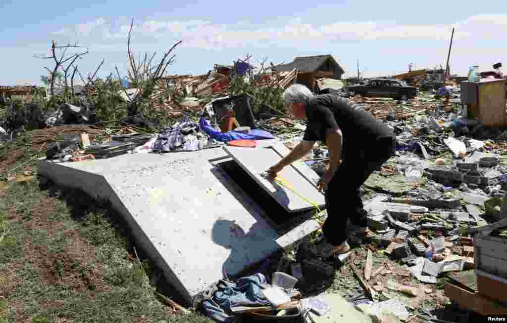 Charles Taber opens the two-week old storm shelter that saved his life in the May 20 tornado in Oklahoma City, Oklahoma, May 22, 2013. 