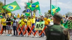 Supporters of President Jair Bolsonaro protest against quarantine and social distancing measures imposed by governors and mayors and demand military intervention (AI-5) in Brasilia, on April 19, 2020.