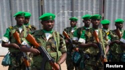 FILE - The first Rwandan soldiers who are part of the African Union peacekeeping force in the Central African Republic (MISCA) prepare to receive a welcome speech by their superiors shortly after landing at the airport of the capital Bangui.