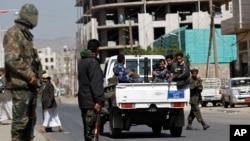 FILE - Yemeni soldiers guard in a street in Sanaa.