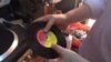 Melodica Music Store owner Abdul Karim plays a 45 RPM album recorded at the store years ago. (VOA / G. Joselow)