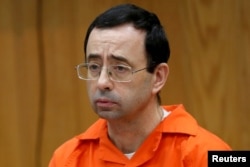 FILE PHOTO: Larry Nassar, a former team USA Gymnastics doctor who pleaded guilty in November 2017 to sexual assault, listens to victims impact statements during his sentencing in the Eaton County Circuit Court in Charlotte, Michigan, Jan. 31, 2018.