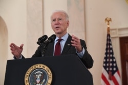 US President Joe Biden speaks about lives lost to Covid after death toll passed 500,000, in the Cross Hall of the White House in Washington, DC, February 22, 2021.