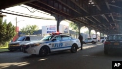 FILE - New York City police secure the scene where two men were shot as they left prayers at a mosque.