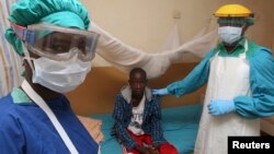 FILE - A nurse and doctor stand by a patient in a Lassa fever ward at Kenema Government Hospital in southeastern Sierra Leone, Feb. 7, 2011.