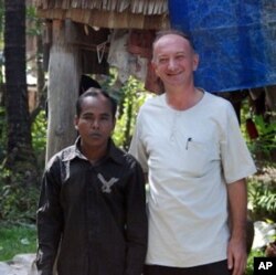 Linguist and S'aoch scholar Jean-Michel Filippi (right) stands in the village with Mr. Tuem, the son of the village chief. Mr. Tuem is one of just 10 villagers who is fluent in the S'aoch language, 19 Jan 2010