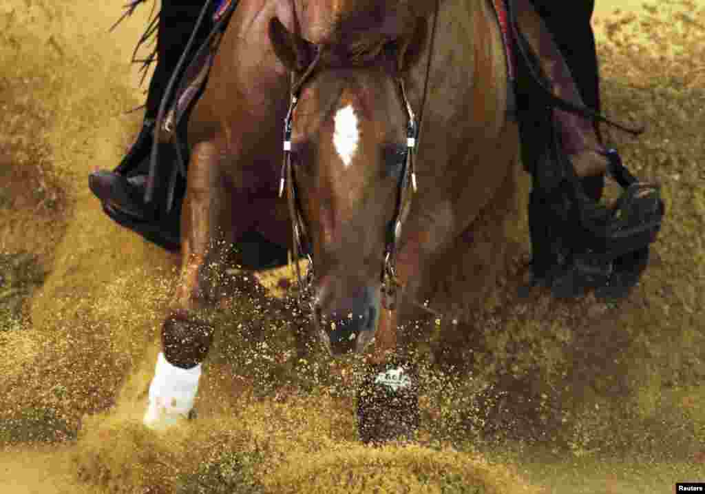 Britain's Josh Collins riding Spook a Little competes in the team reining competition and 1st individual qualifying at the World Equestrian Games at the d'Ornano stadium in Caen, France.