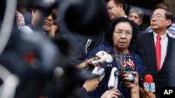 FILE - Thida Thavornseth, a senior member of the United Front for Democracy against Dictatorship (UDD) or Red Shirts, talks to reporters as she leaves the Bangkok South Criminal Court in Bangkok, Thailand, April 30, 2015. 