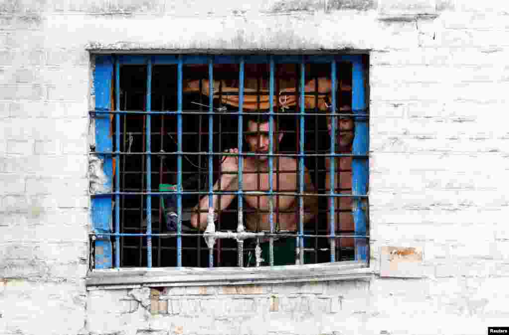 Detainees look out from a prison cell at a compound of the Lukyanivska detention center in Kyiv, Ukraine.