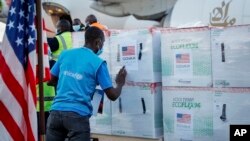 FILE - A UNICEF worker checks boxes of the Moderna coronavirus vaccine, donated by the U.S. government via the COVAX facility, after their arrival at the airport in Nairobi, Kenya, Aug. 23, 2021. 