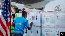 FILE - A UNICEF worker checks boxes of the Moderna coronavirus vaccine, donated by the U.S. government via the COVAX facility, after their arrival at the airport in Nairobi, Kenya, Aug. 23, 2021.