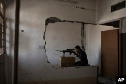 An Iraqi Special Forces sniper watches Islamic State positions as Iraqi forces continue their advance in the Old City of Mosul, Iraq, July 5, 2017.