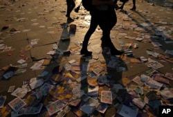 People walk on leaflets regarding the upcoming referendum in Istanbul, April 15, 2017. Turkey is heading to a contentious referendum on April 16, on constitutional reforms to expand Turkey's President Recep Tayyip Erdogan's powers.