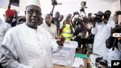 Senegal's incumbent President Macky Sall casts his vote during the presidential election at a polling station in Fatick, Senegal, Feb. 24, 2019. 