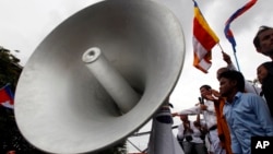 Cambodian protesters use a loudspeaker for express their comment during a protest at a blocked main street in front of Vietnamese Embassy in Phnom Penh, Cambodia, Wednesday, Oct. 8, 2014. 