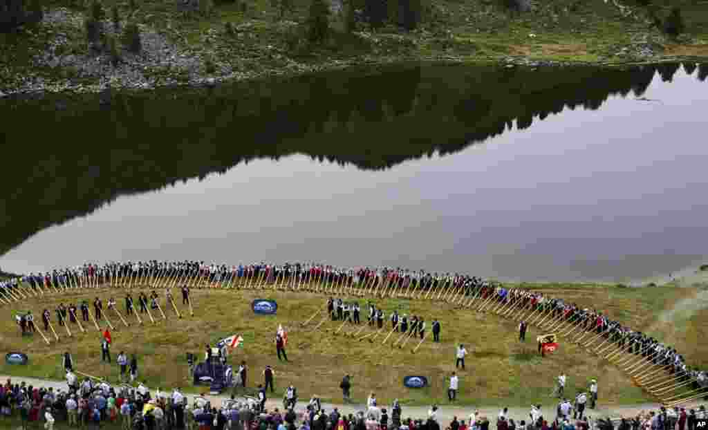 Alpenhorn players prepare to perform along the Lac de Tracouet, situated 2200 meters (7220 feet) above sea level in Haute-Nendaz, canton of Valais, Switzerland.