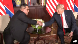 川普与金正恩2018年6月12日在会谈开始前握手（美联社）