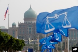 The flags of Malaysia's ruling party National Front coalition flutter in front of Prime Minister's office in Putrajaya, Malaysia, April 6, 2018. Malaysia's Prime Minister Najib Razak says he'll dissolve Parliament Saturday, paving the way for general election, likely in early May.