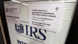 FILE - Doors at the Internal Revenue Service in the Henry M. Jackson Federal Building are locked and covered with blinds as a sign posted advises that the office will be closed during the partial government shutdown in Seattle, Jan. 16, 2019.