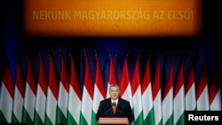 Hungarian Prime Minister Viktor Orban delivers his annual state of the nation speech in Budapest, Hungary, Feb. 18, 2018. Slogan reads "For us, Hungary first!" 