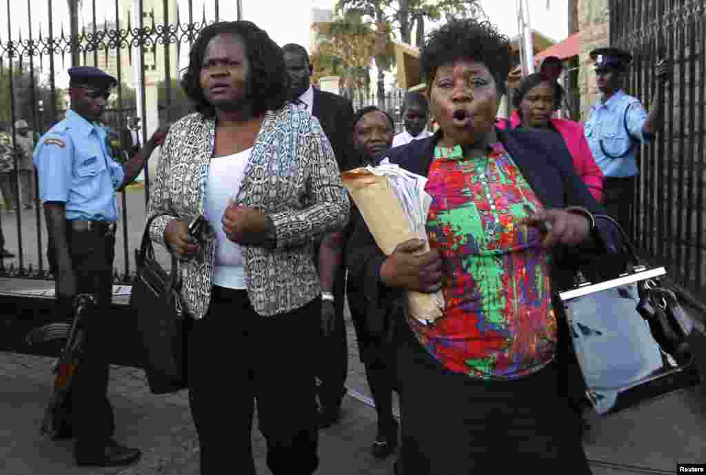 Kenyan members of parliament Gladys Wanga, left, and Christine Mbaya leave the National Assembly to protest against the approval of new anti-terrorism laws in Kenya's capital Nairobi, Dec. 18, 2014.