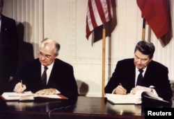 U.S. -- File photo of U.S. President Ronald Reagan (R) and Soviet President Mikhail Gorbachev the Intermediate-Range Nuclear Forces (INF) treaty at the White House, on December 8 1987