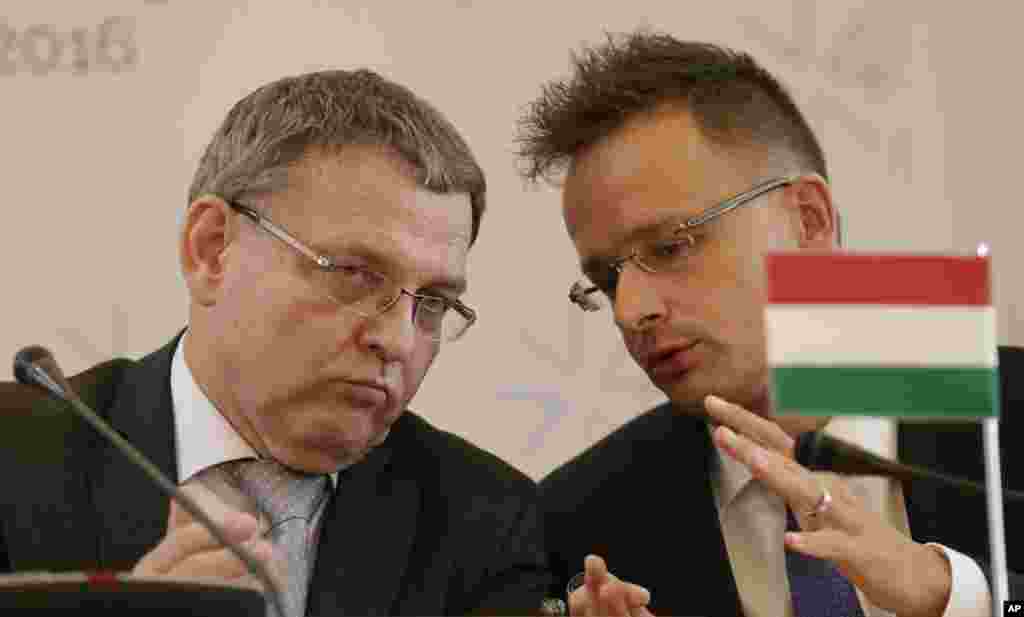 Czech Republic&#39;s FM Lubomir Zaoralek, left, talks to Hungarian FM Peter Szijjarto during a press conference as the Visegrad Group foreign ministers meet their counterparts from Germany and Luxembourg to talk about the current migration crisis in Prague, Czech Republic.