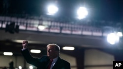 President Donald Trump pumps his fist after a campaign rally at Erie International Airport, Tom Ridge Field, Tuesday, Oct. 20, 2020, in Erie, Pa.